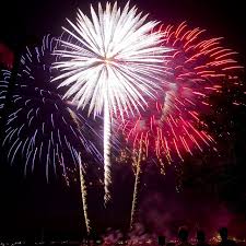 Three fireworks exploding in colors of blue white and red