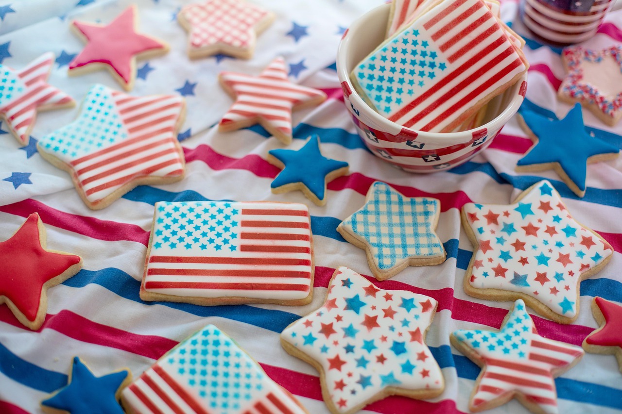 cookies decorated with United States flags and stars in the colors red white and blue